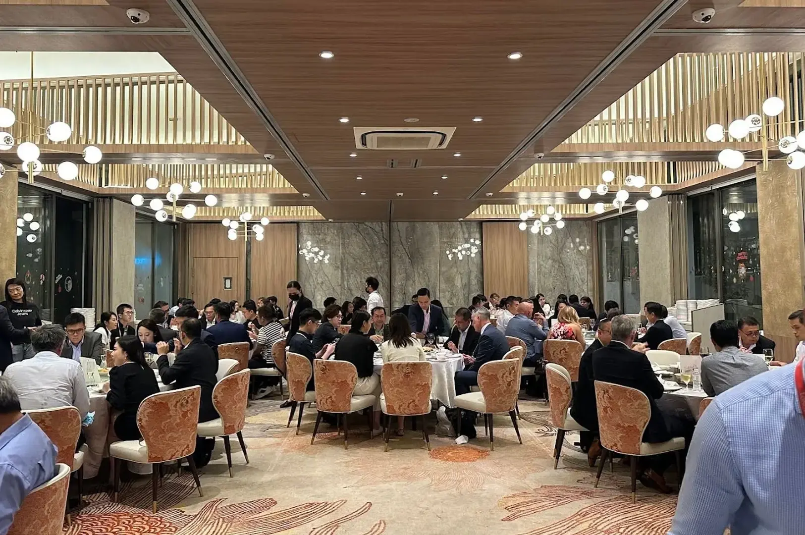 Busy Singapore seafood restaurant dining room filled with diners during dinner service