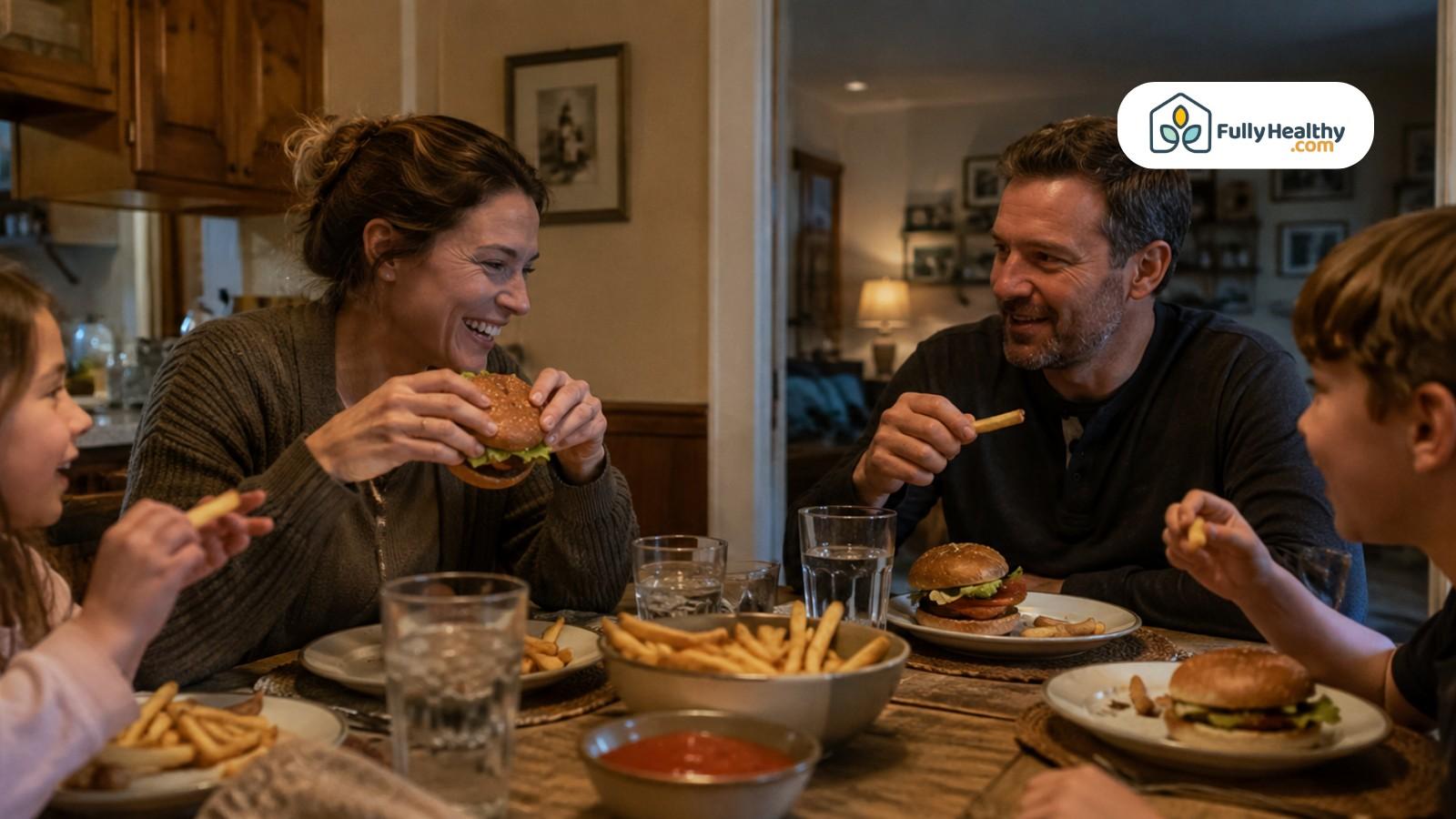 Family enjoying gluten-free burgers and fries with ketchup at dinner table
