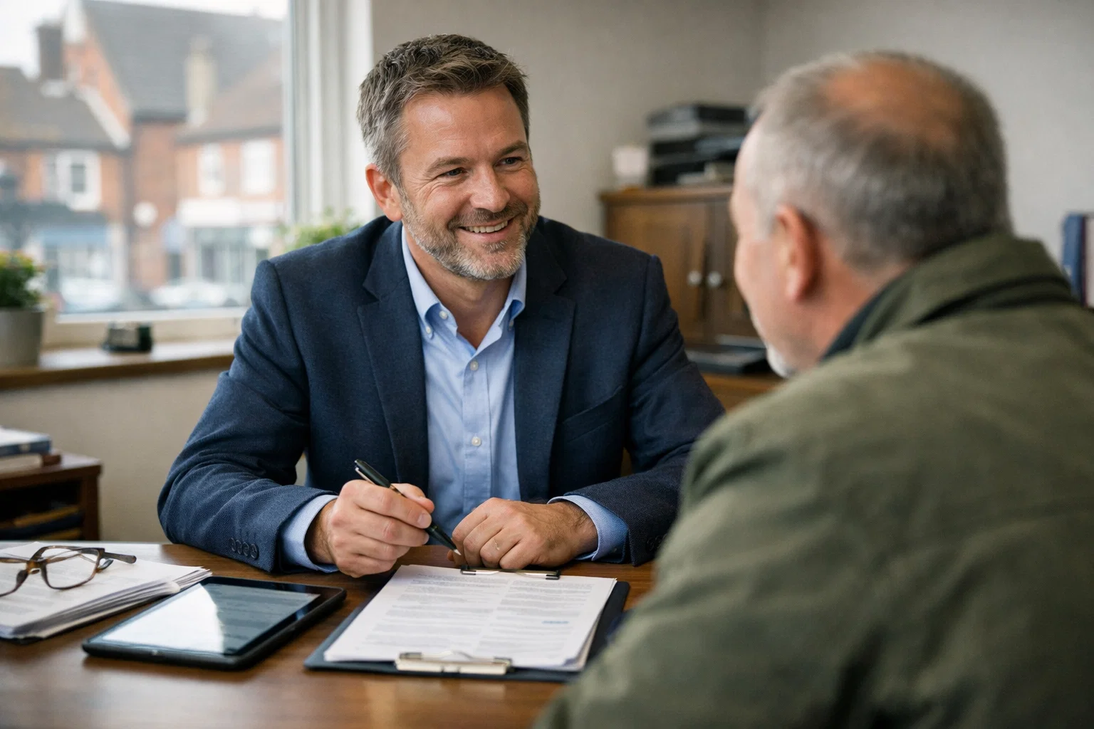 Local insurance broker meeting client in town office