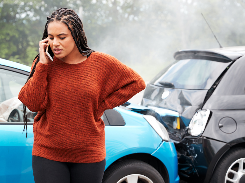 An image showing a person on the phone after an auto accident in Alabama.