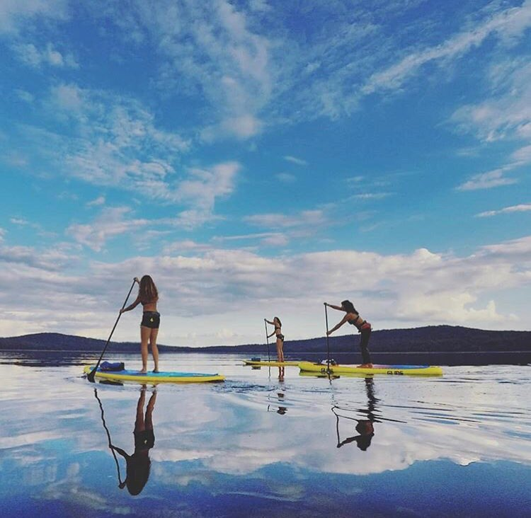 women on paddle boards