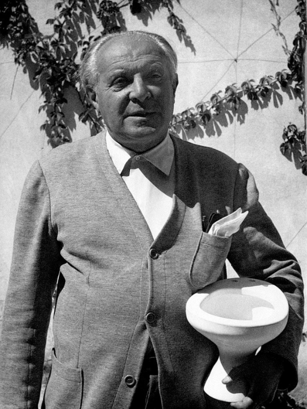Gio Ponti (1891-1979) in the 1950s, holding a ceramic piece made of modern materials, was also a master of graphic design in his Magazine Domus