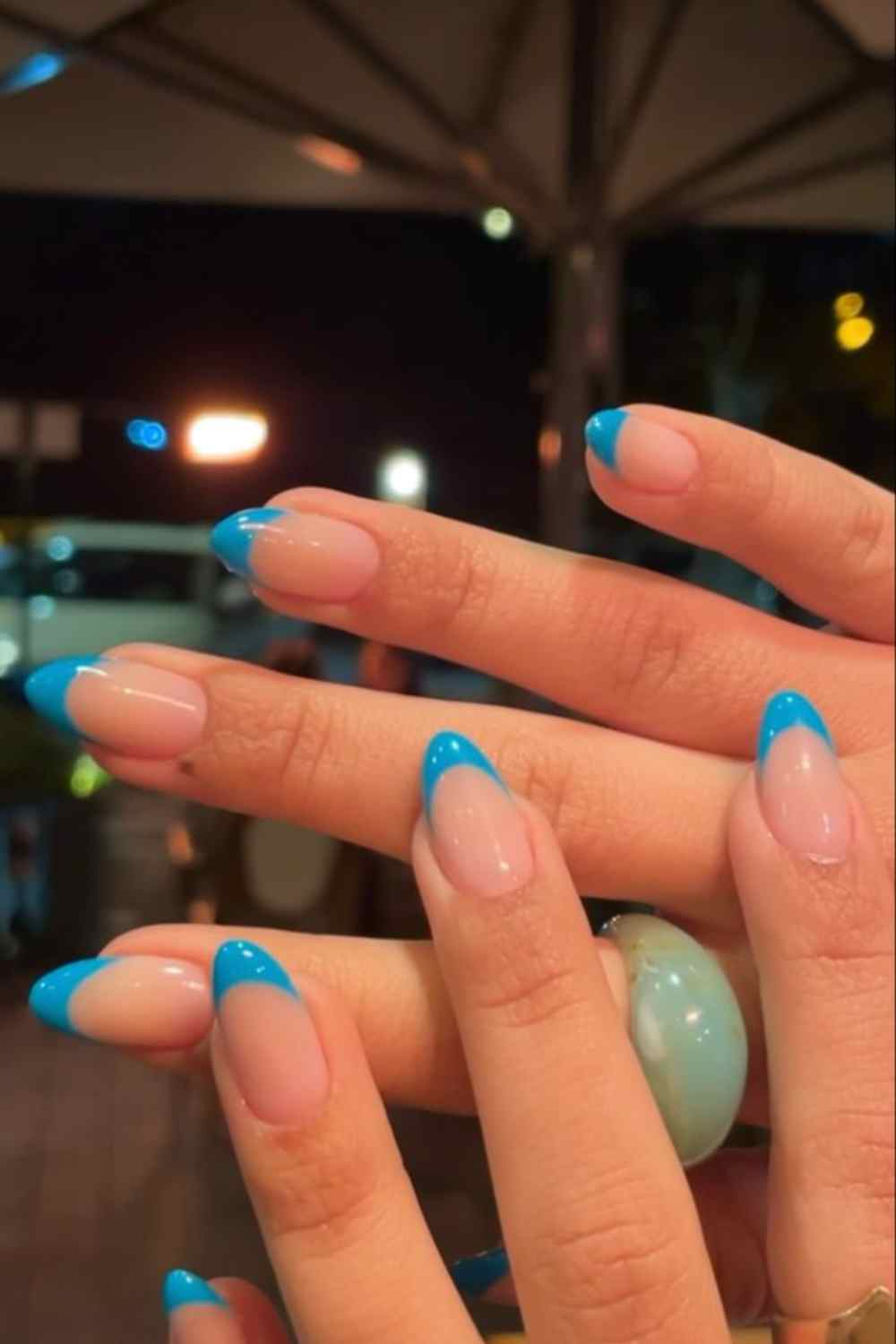 Blue tip nail art design done by a nail artist