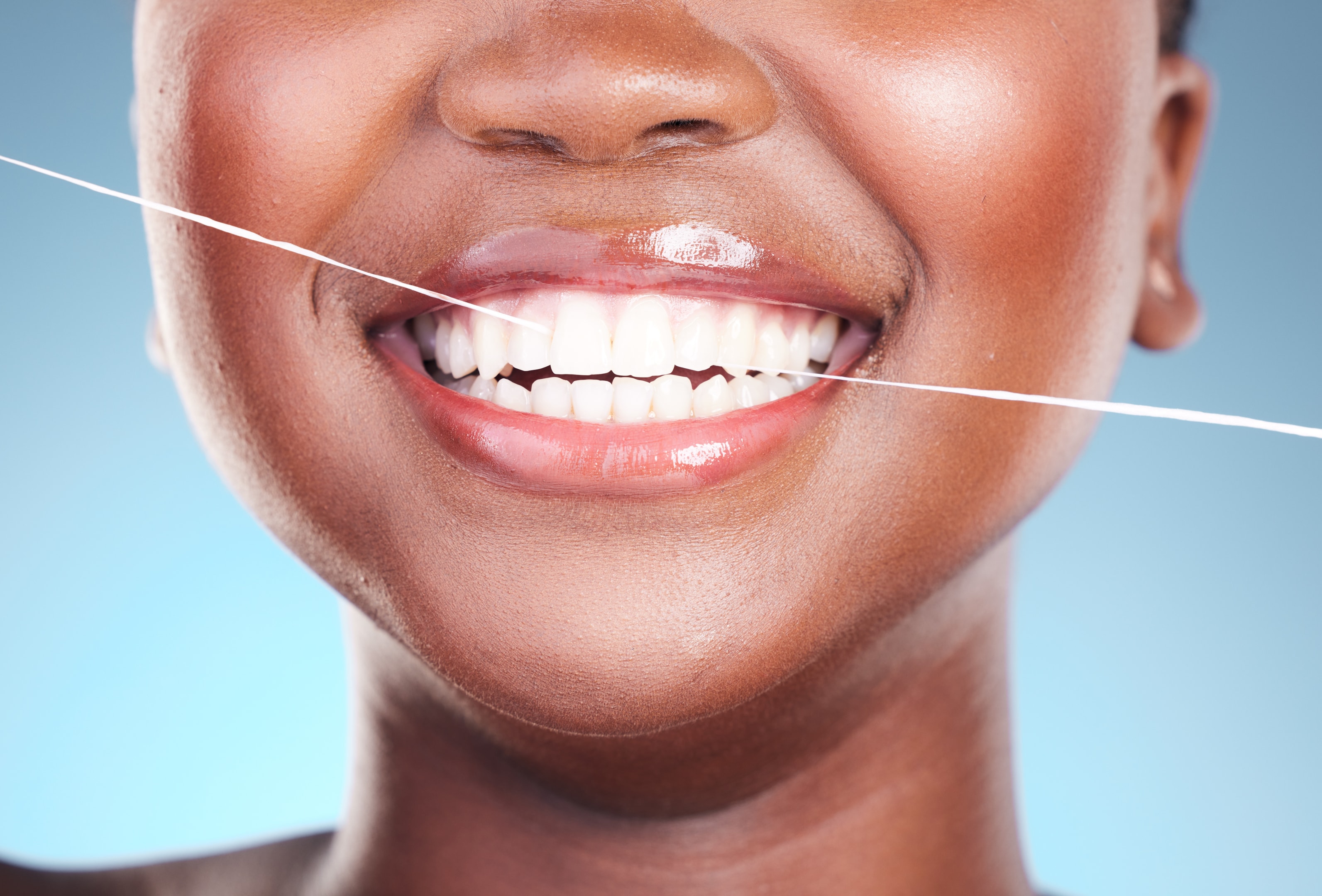 woman smiling while recovering after wisdom tooth extraction 