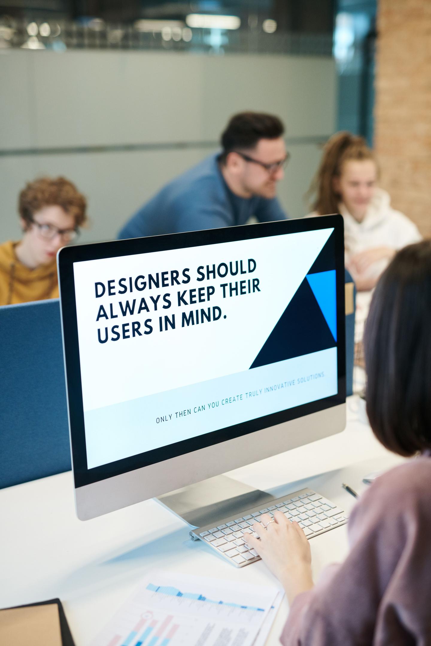 Computer monitor featuring the words "Designers should always keep their users in mind."