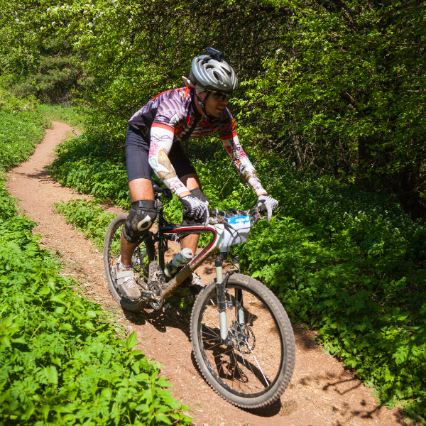 An image showing a mountain biker navigating a rugged trail.