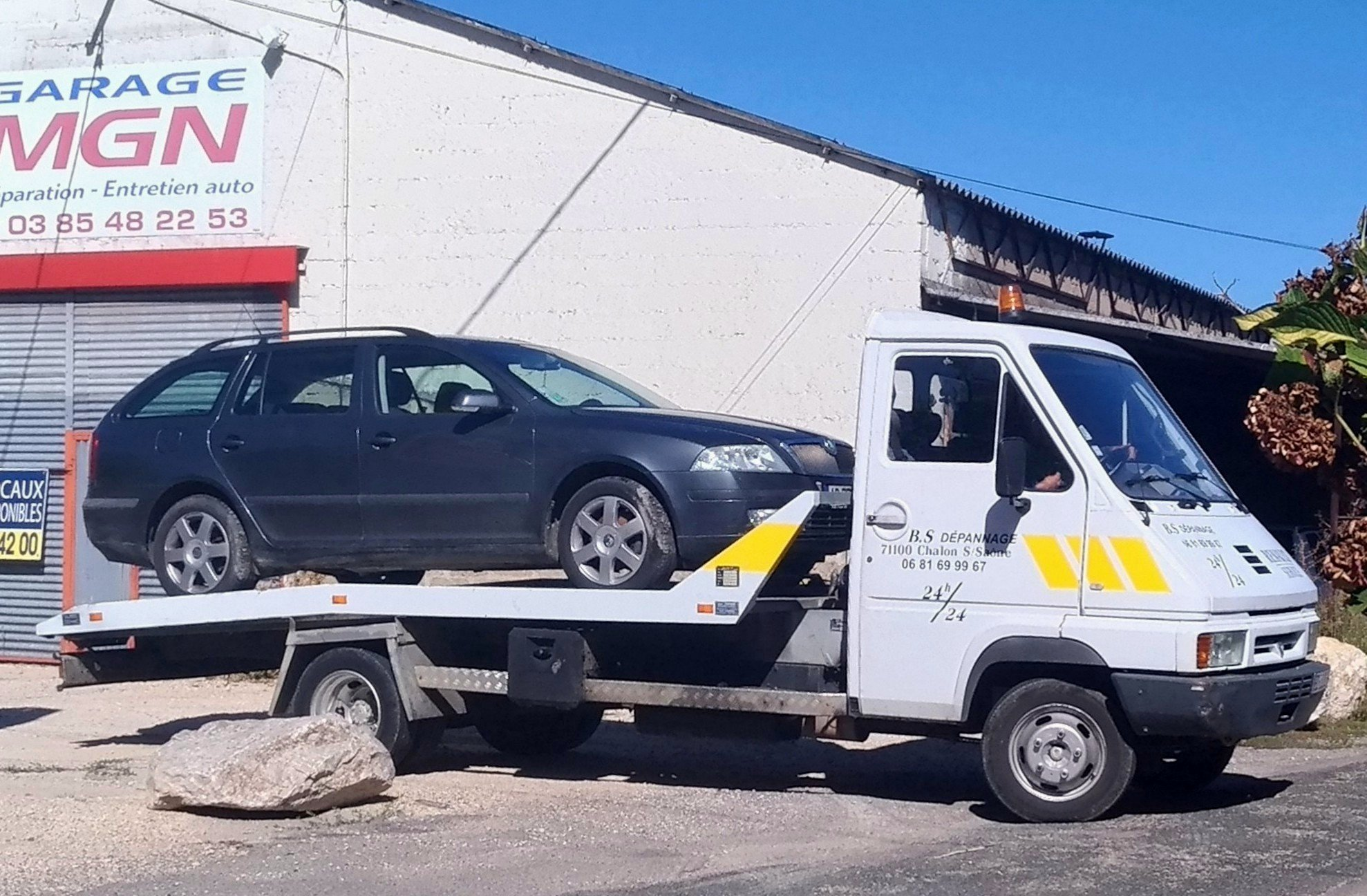 A tow truck driver picking up a junk car without a title
