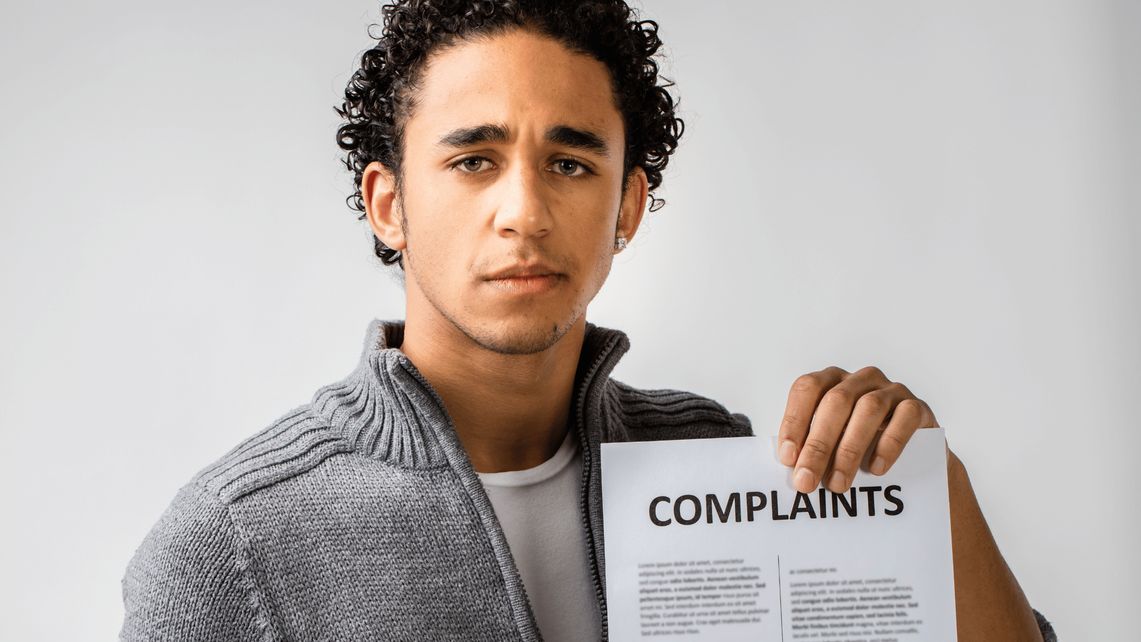 Frustrated tenant holding a written complaint about rental issues