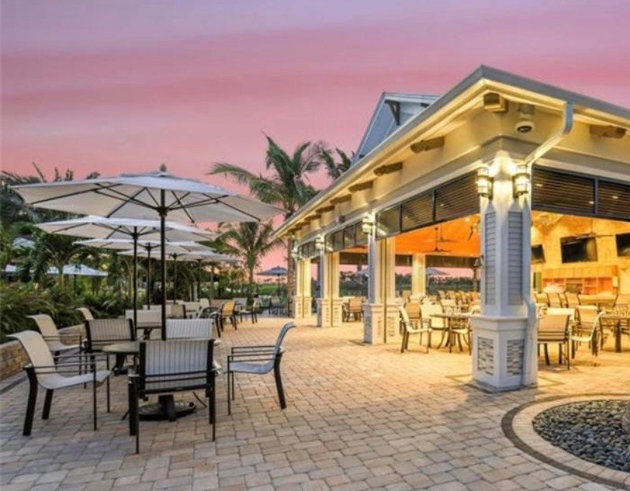 Residents of the Esplanade Lake Club in Fort Myers, Florida, are enjoying various outdoor activities by the lake, surrounded by the community's resort-style amenities, including private boat docks and recreational facilities. The picturesque lakefront promenade offers a perfect setting for an active lifestyle, showcasing the natural beauty of Southwest Florida.