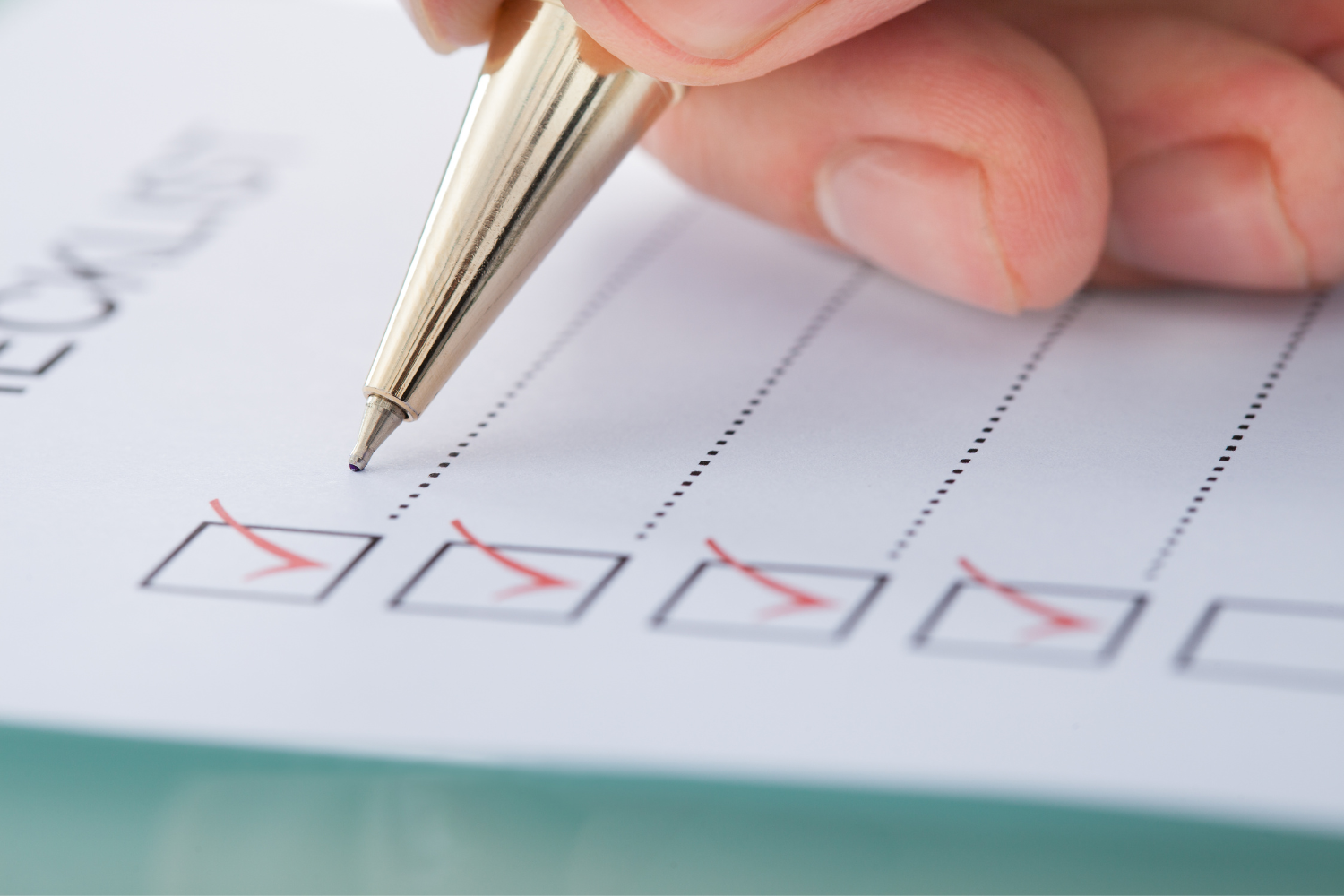Person placing a check mark on a checklist.