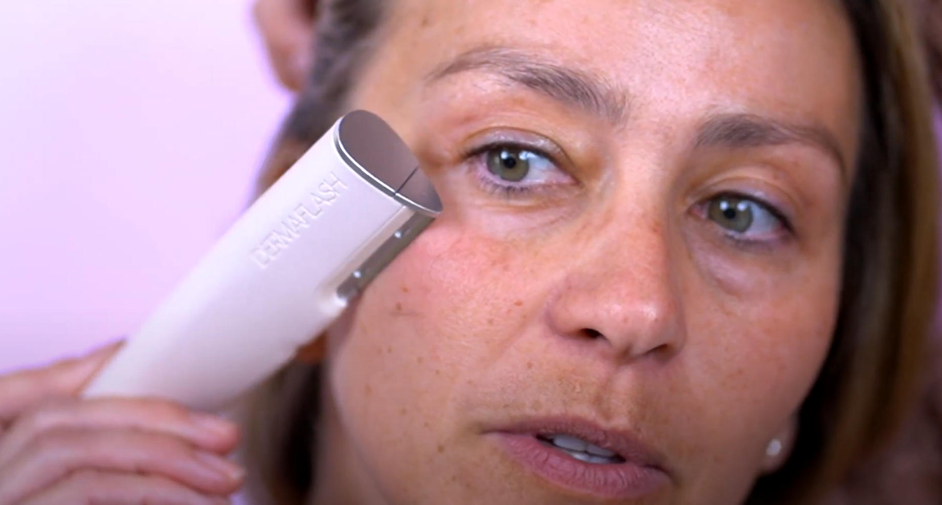 a woman using the dermaflash luxe