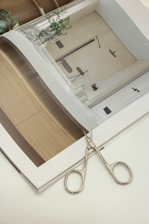 pen magazine showing a minimalist interior, with small silver scissors placed on the page.