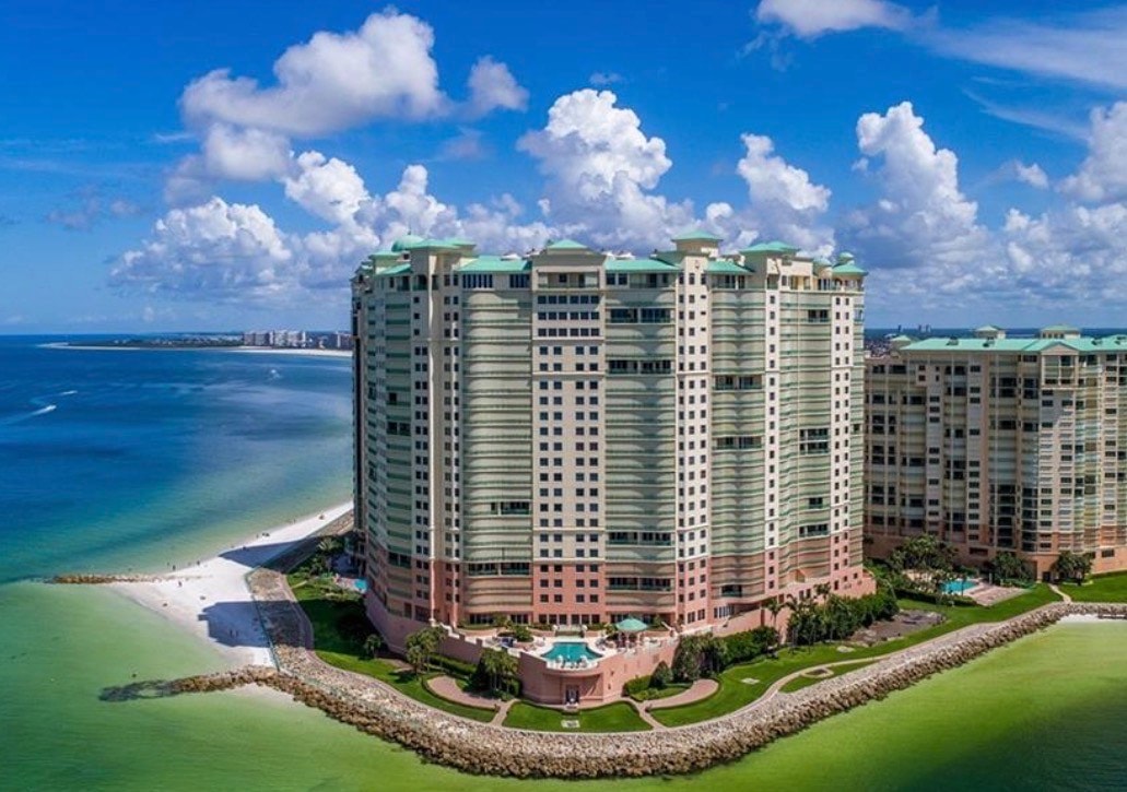 An aerial view showcases luxury waterfront properties on South Marco Island, with the Gulf of Mexico shimmering in the background. This image highlights the stunning landscape of island living, featuring upscale homes and beautiful beach access along the Paradise Coast.