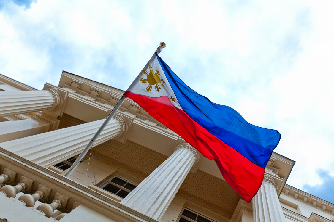 Philippine flag waving outside a government building