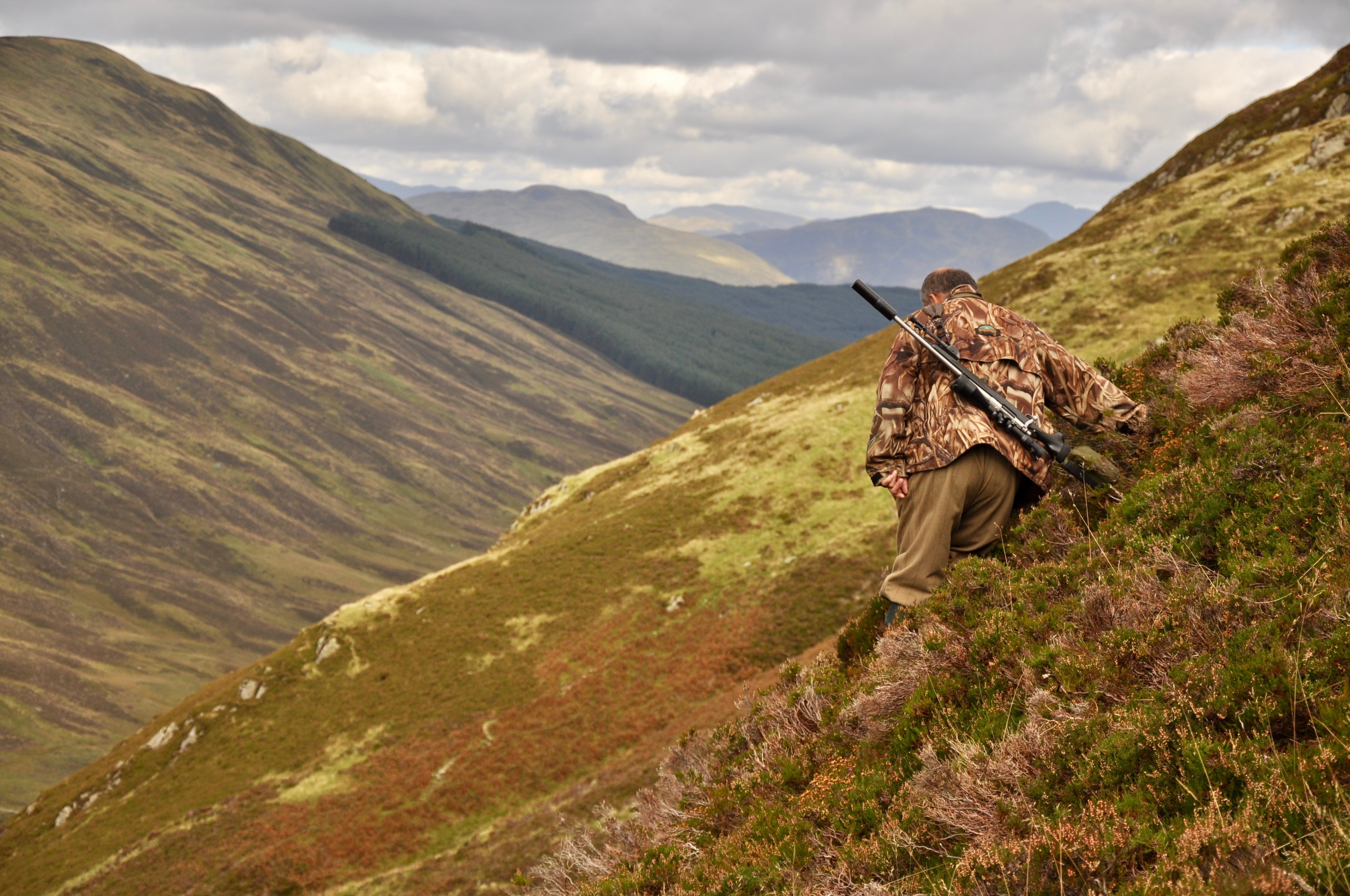 A picture of a hunter in Mongolia, using the spot and stalk method to hunt