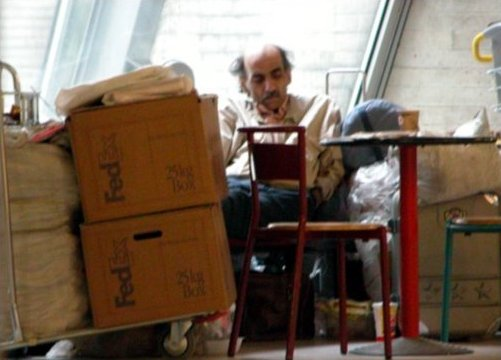 Mehran Karimi Nasseri reading at an airport.