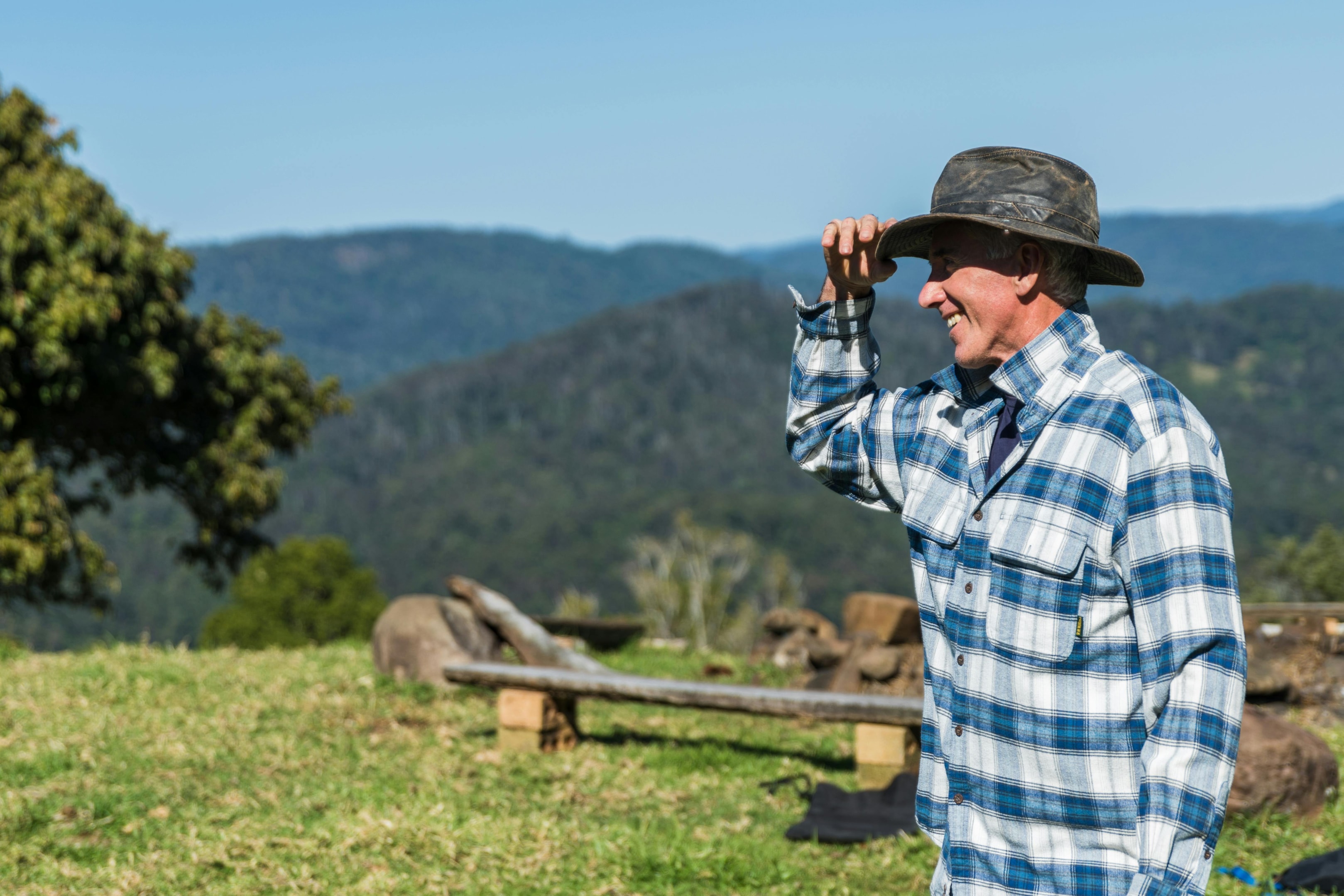 man in hat standing in his property