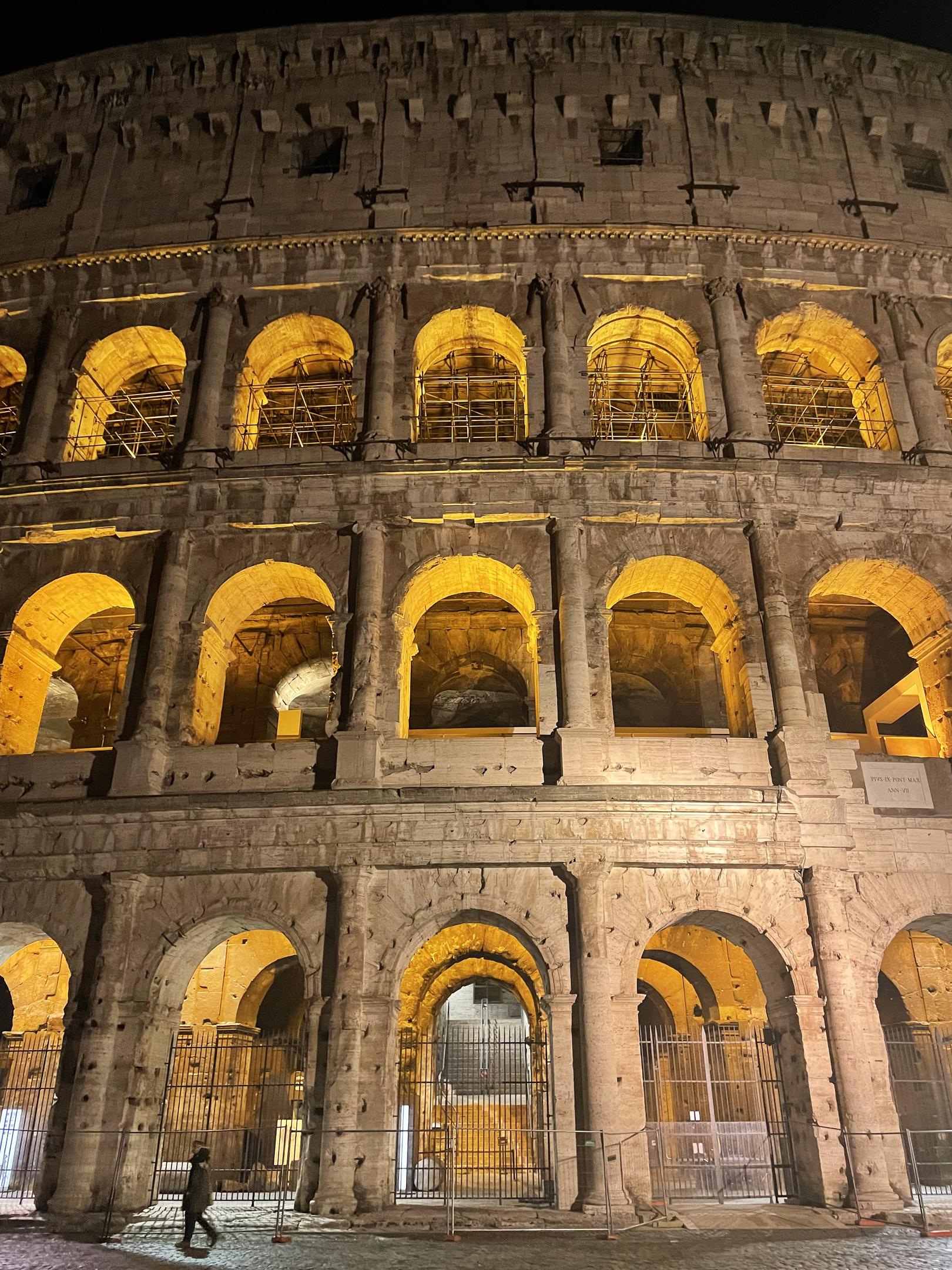 The Colosseum illuminated at night in Rome, Italy