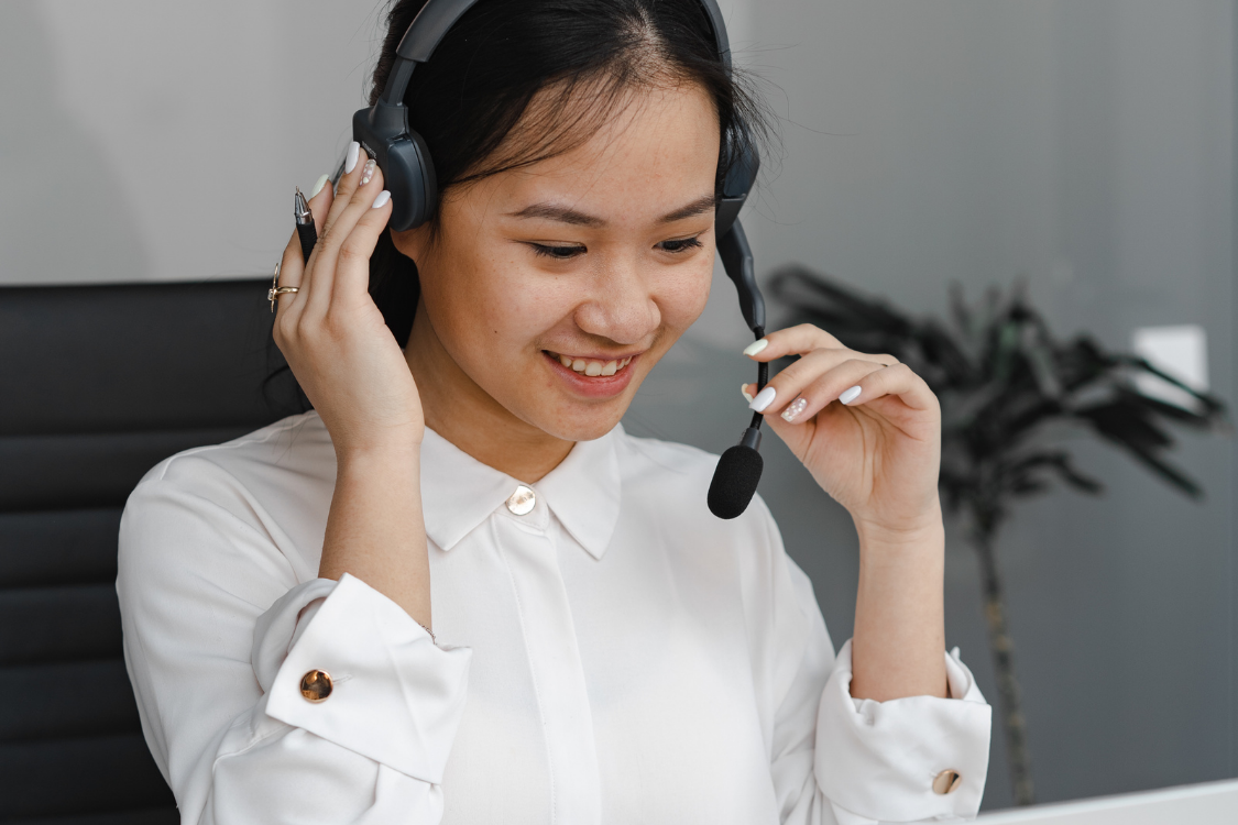 Customer service virtual assistant with headset smiling during support call