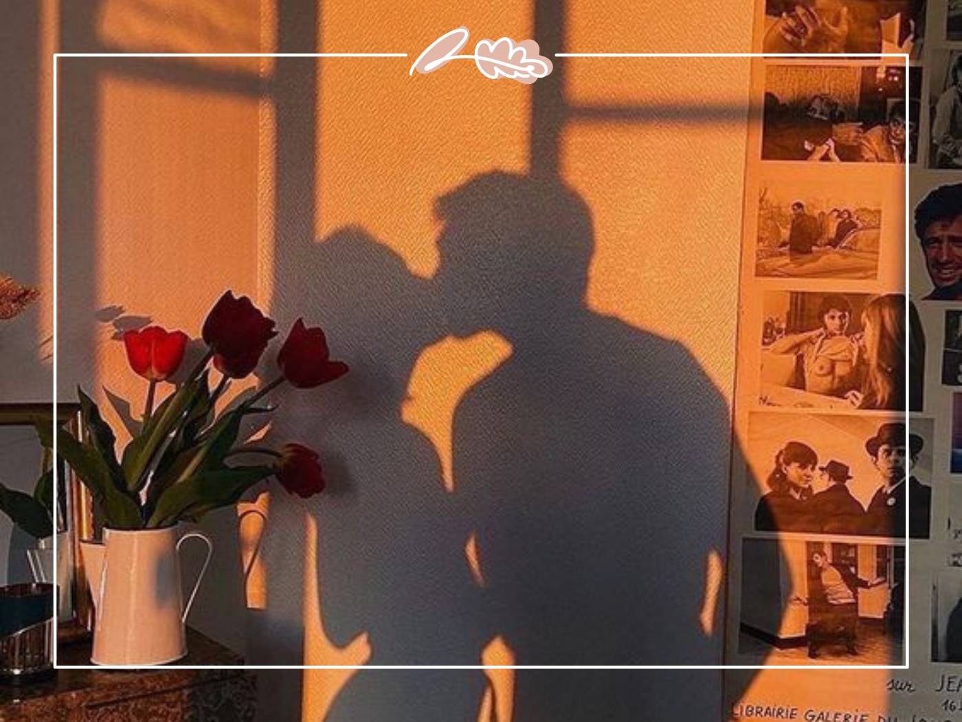 A romantic shadow of a couple kissing in front of a wall decorated with pictures and a vase of red tulips - Fabulous Flowers and Gifts