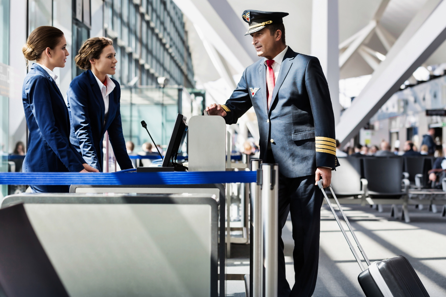 a male pilot and two airhostess talking to each other