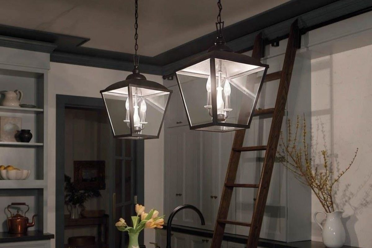 Pendant lights hang above a kitchen island as a dimmable light fixture.