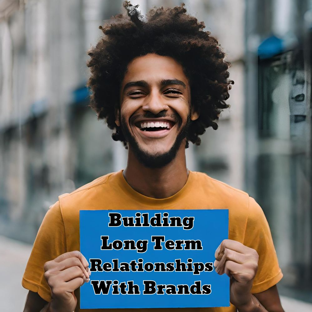 A person smiling while holding a sign with the words "Building Long-Term Relationships with Brands"