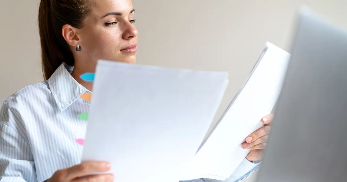Woman preparing tax documents related to single-member LLC vs. sole proprietorship.