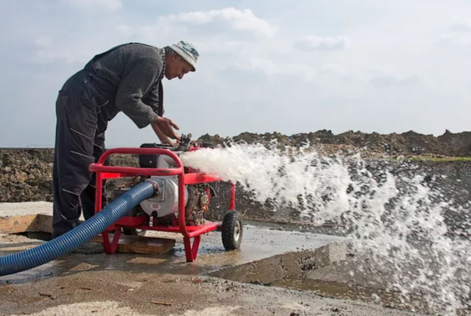 Man using large industrial water pump