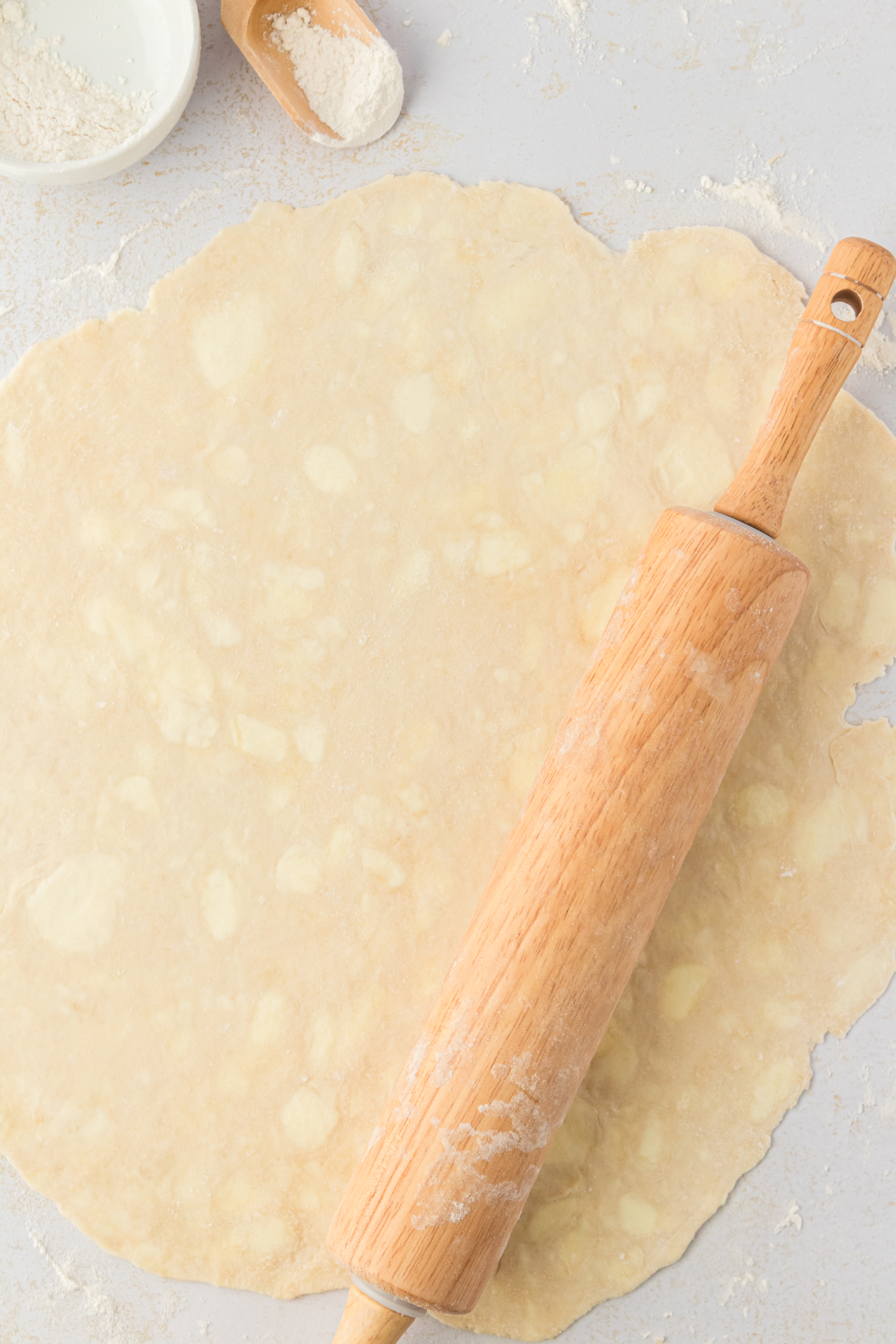 pie dough rolled out with rolling pin