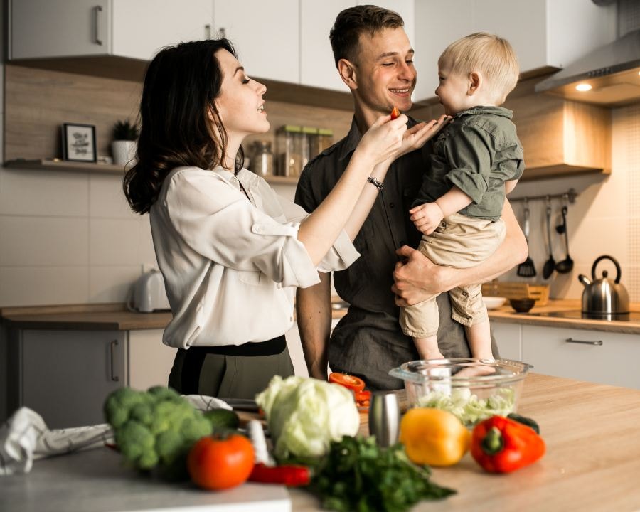 Happy family prepping fresh veggies in a home kitchen — wholesome lifestyle supporting Parasite Cleanse routines and gut health.