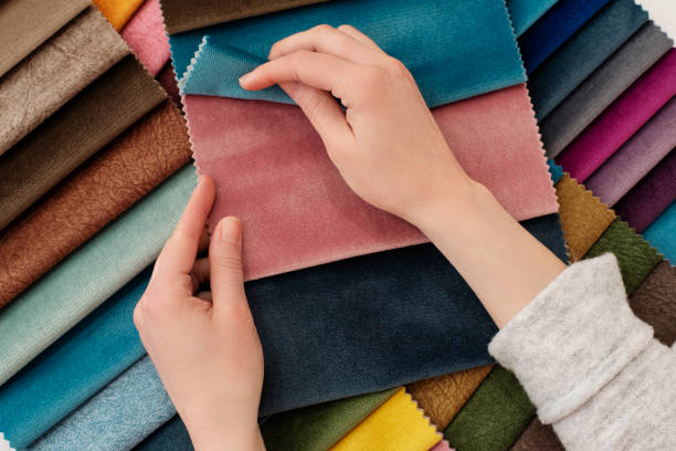 Woman checking fabrics https://www.istockphoto.com/photo/young-woman-with-fabric-samples-for-curtains-at-table-multiple-color-fabric-texture-gm1137526672-303375666