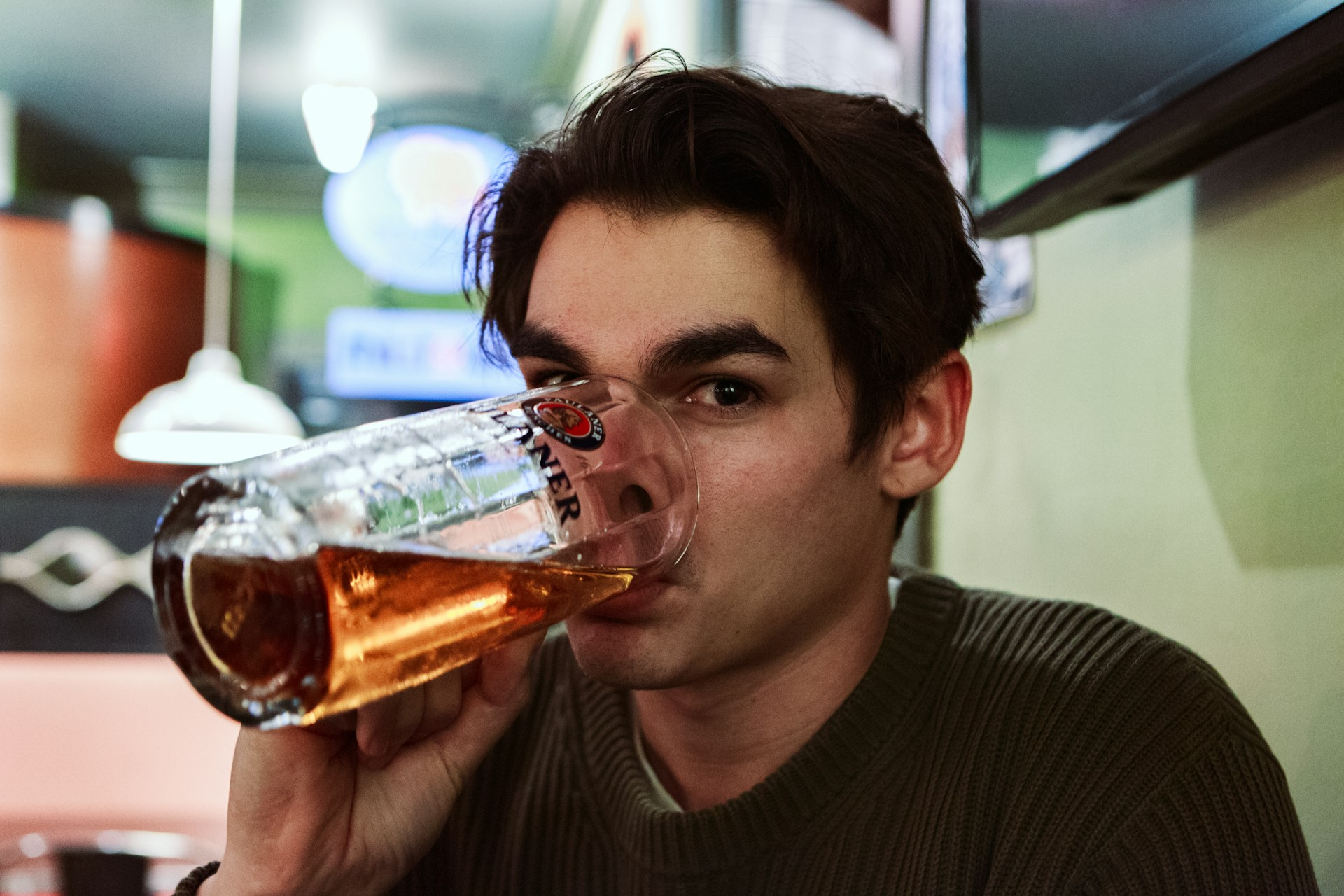 A man drinking a large beer in moderation since he knows heavy drinking can decrease his sperm count