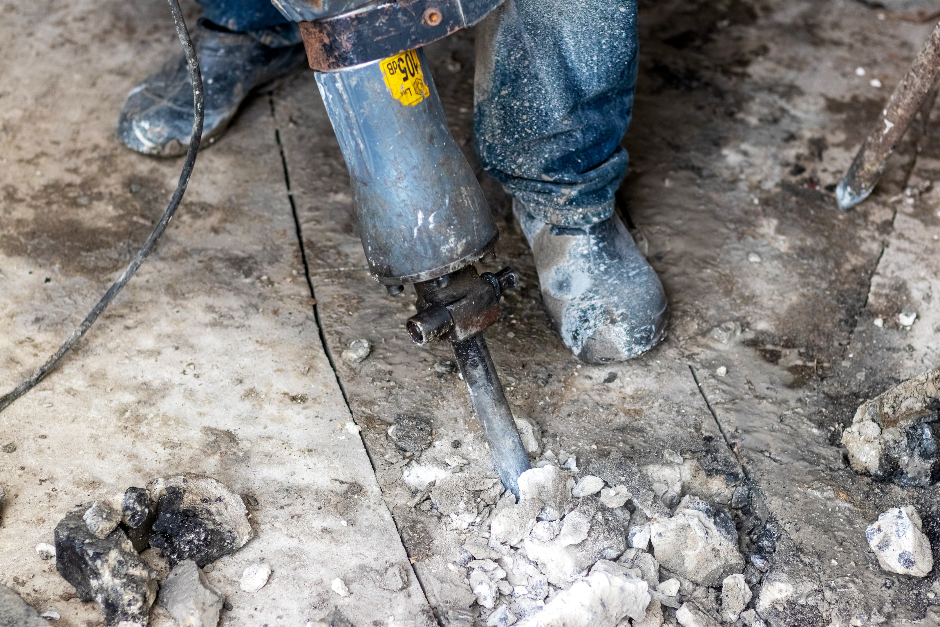 Jackhammer the concrete floor: a messy, loud, and incredibly expensive process