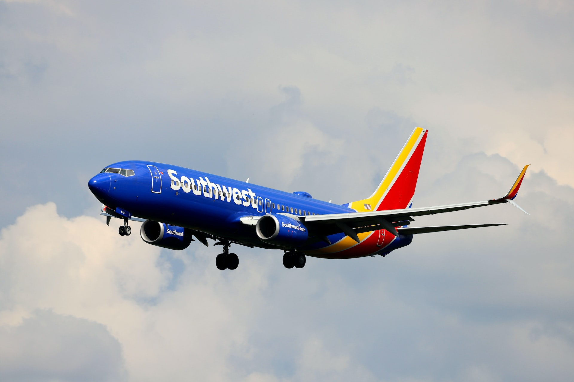 Southwest Airlines aircraft landing on a cloudy day.