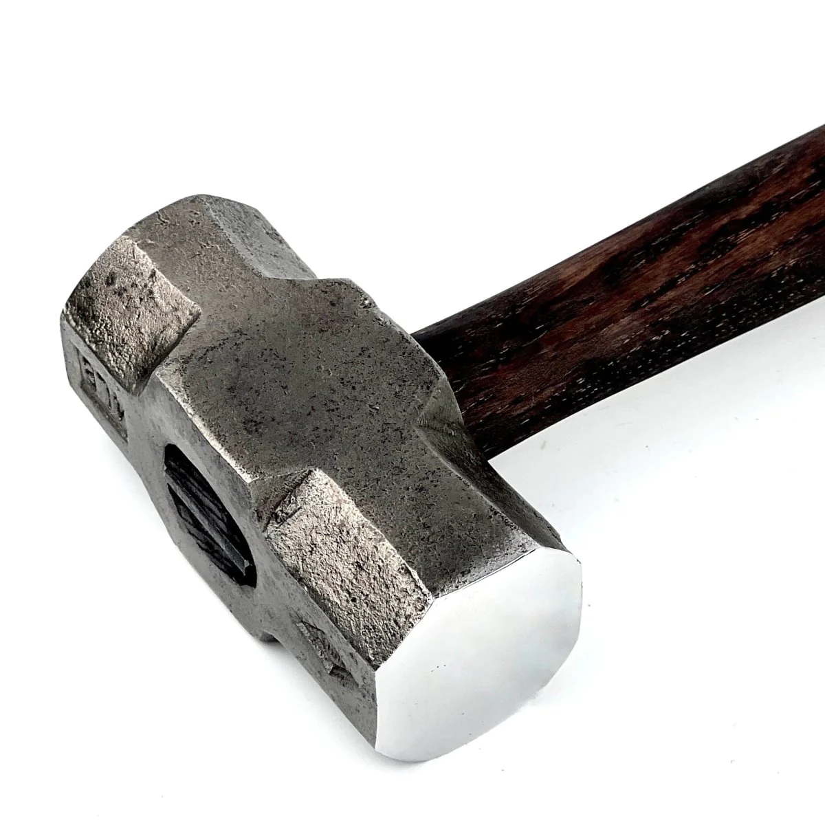 A close-up of a forged tool steel head of a sledge hammer
