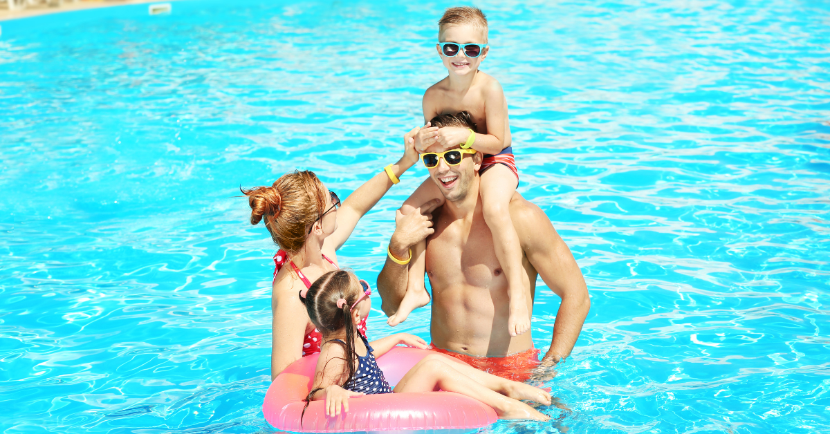 Family with two children enjoying a sunny day in a swimming pool at a Jersey Shore vacation rental