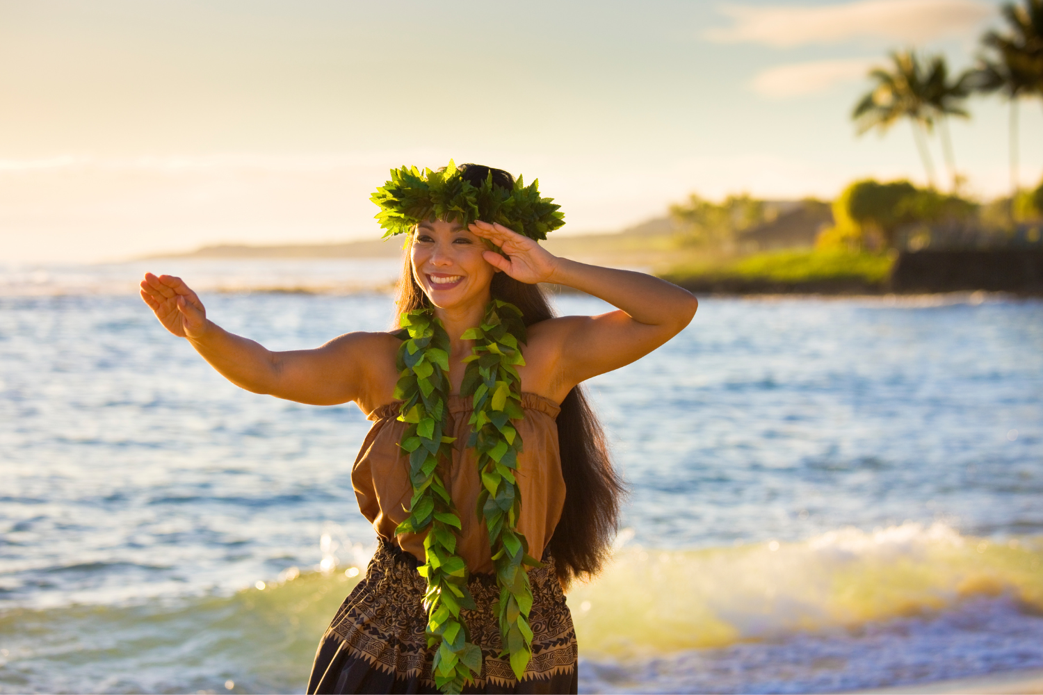 a woman performing hula dance at the beach