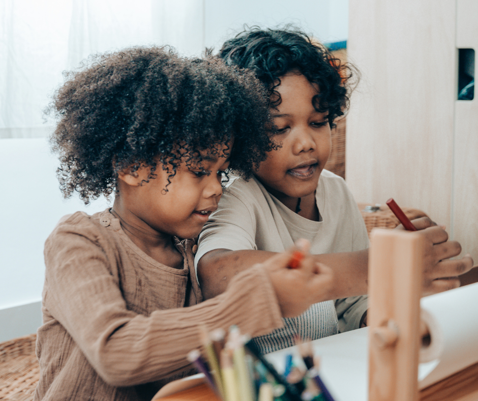 two kids draw together