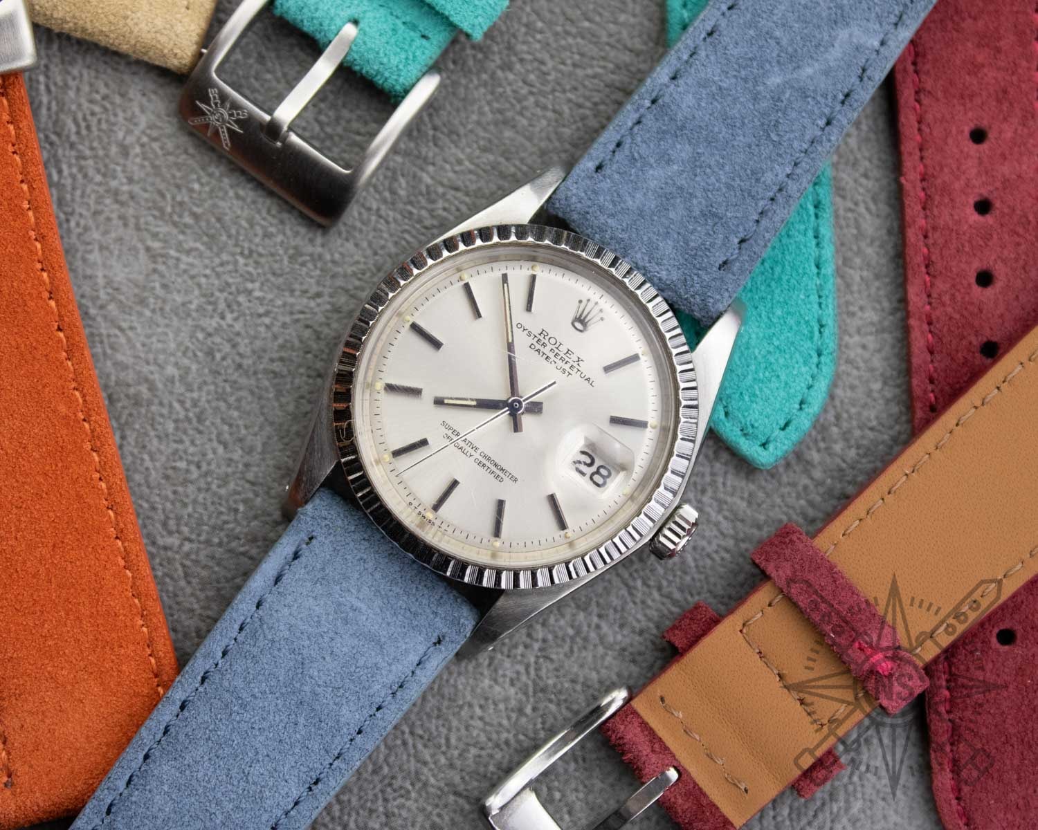 A close-up of a blue suede watch strap showcasing its texture and color.