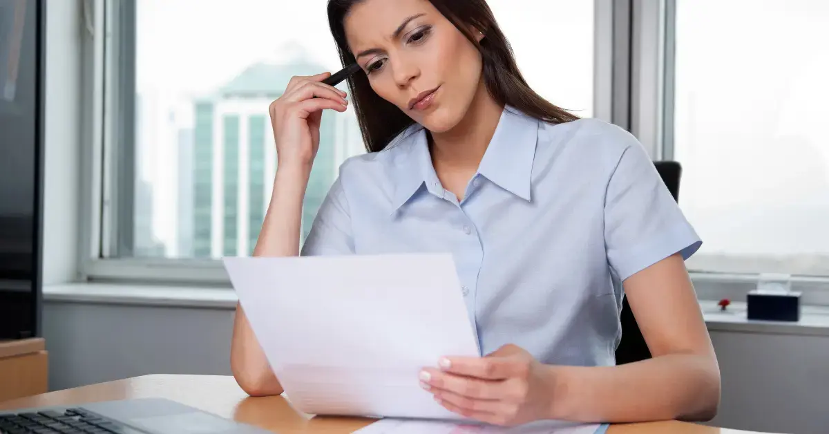 Woman reviewing financial records to understand hobby income vs business income for tax reporting.