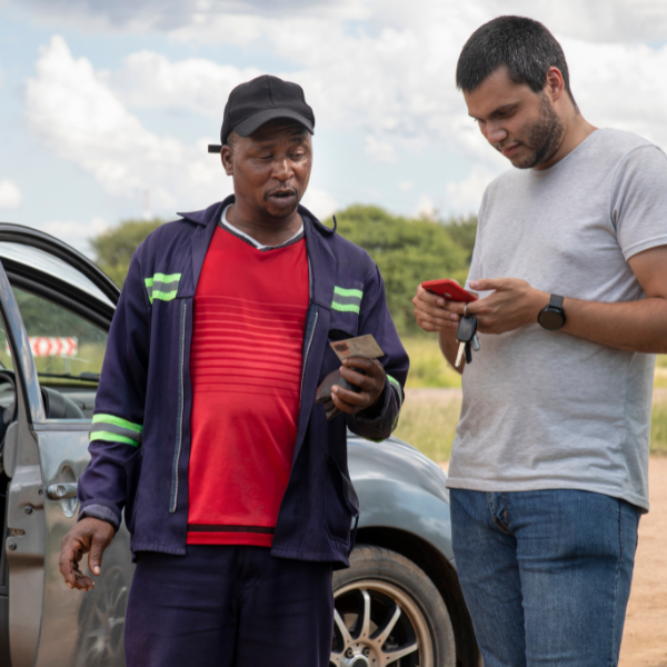 Image showing two people exchanging information after an 18 wheeler accident.