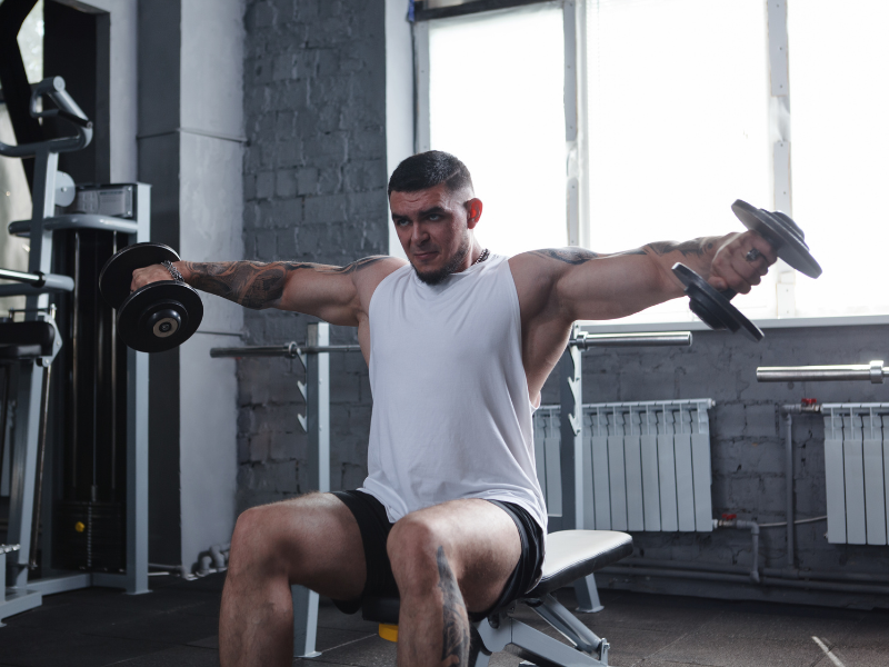 Image of a seated dumbbell lateral raise.