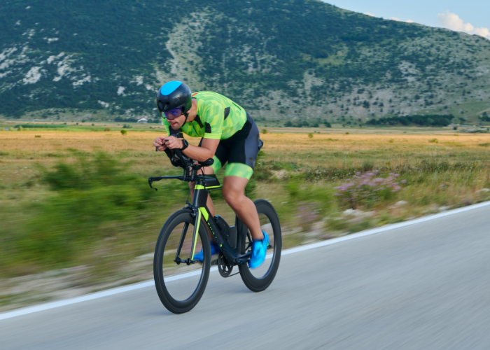 A mountain biker riding a mountain bike and a road biker riding a road bike on a flat surface