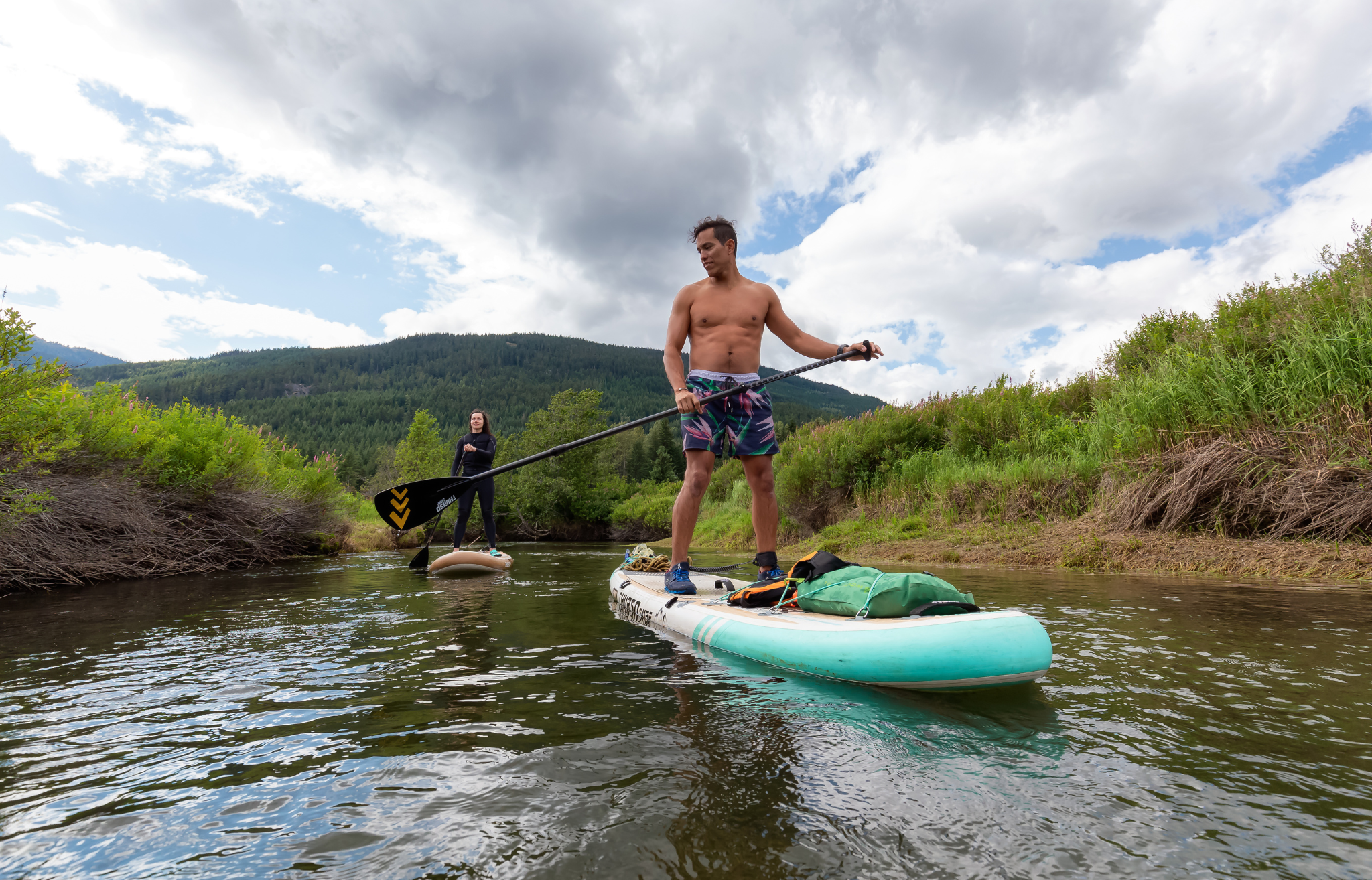Man and woman paddling down a river - Adventure Wise Travel Gear