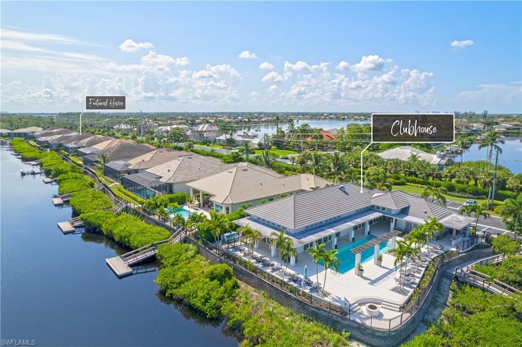 The image depicts a modern coastal home exterior featuring large windows and a welcoming covered porch, set within the serene Hidden Harbor neighborhood in Fort Myers, Florida. This stylish residence reflects the luxury and beauty of the Hidden Harbor lifestyle, complemented by lush landscaping and easy access to nearby amenities.