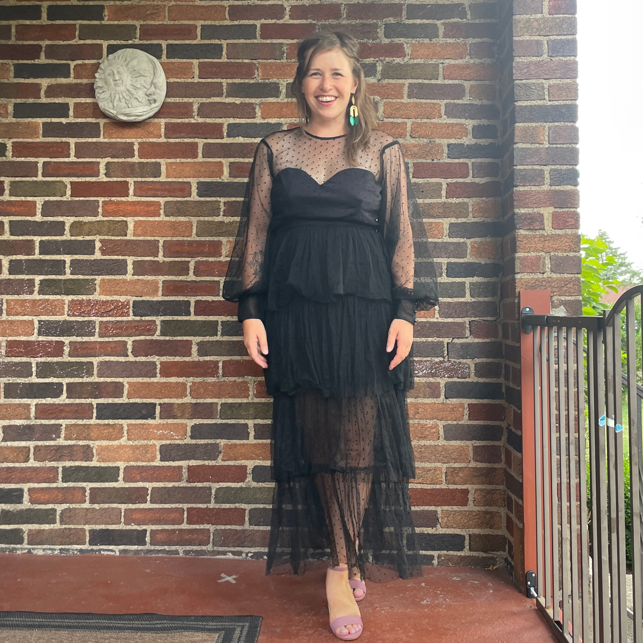 Christen showcasing her Alice McCall Mysteria Ruffled Midi Dress from Nuuly's clothing subscription service.