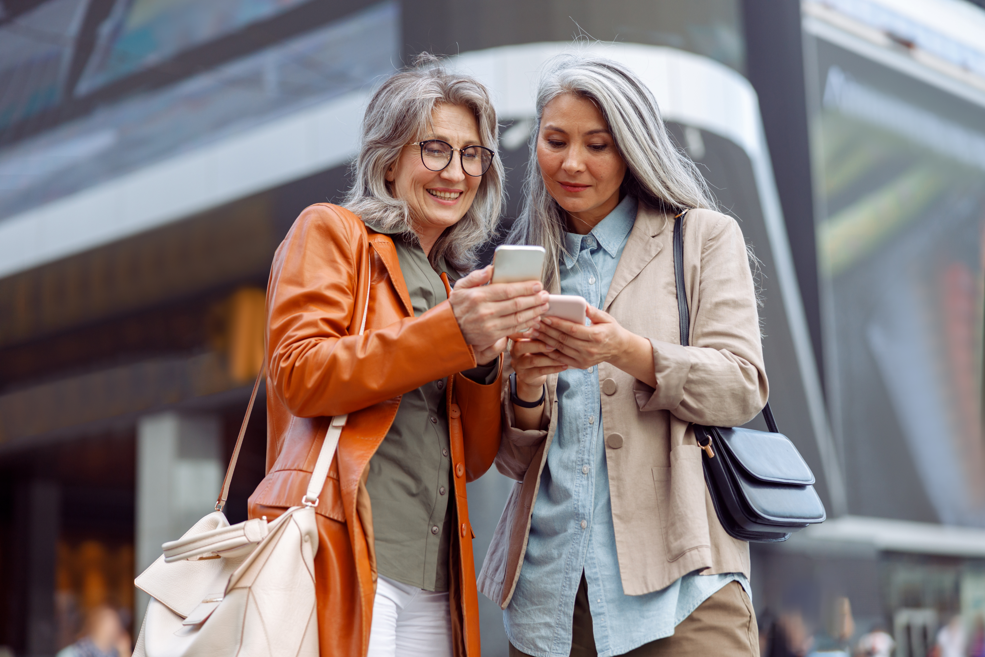 Two older women using mobile phones