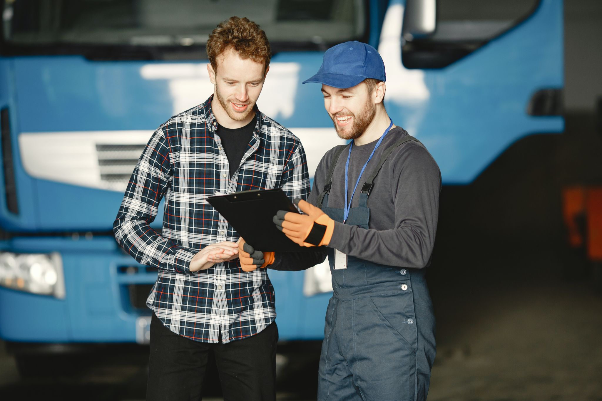 A mechanic showing a customer a clipboard