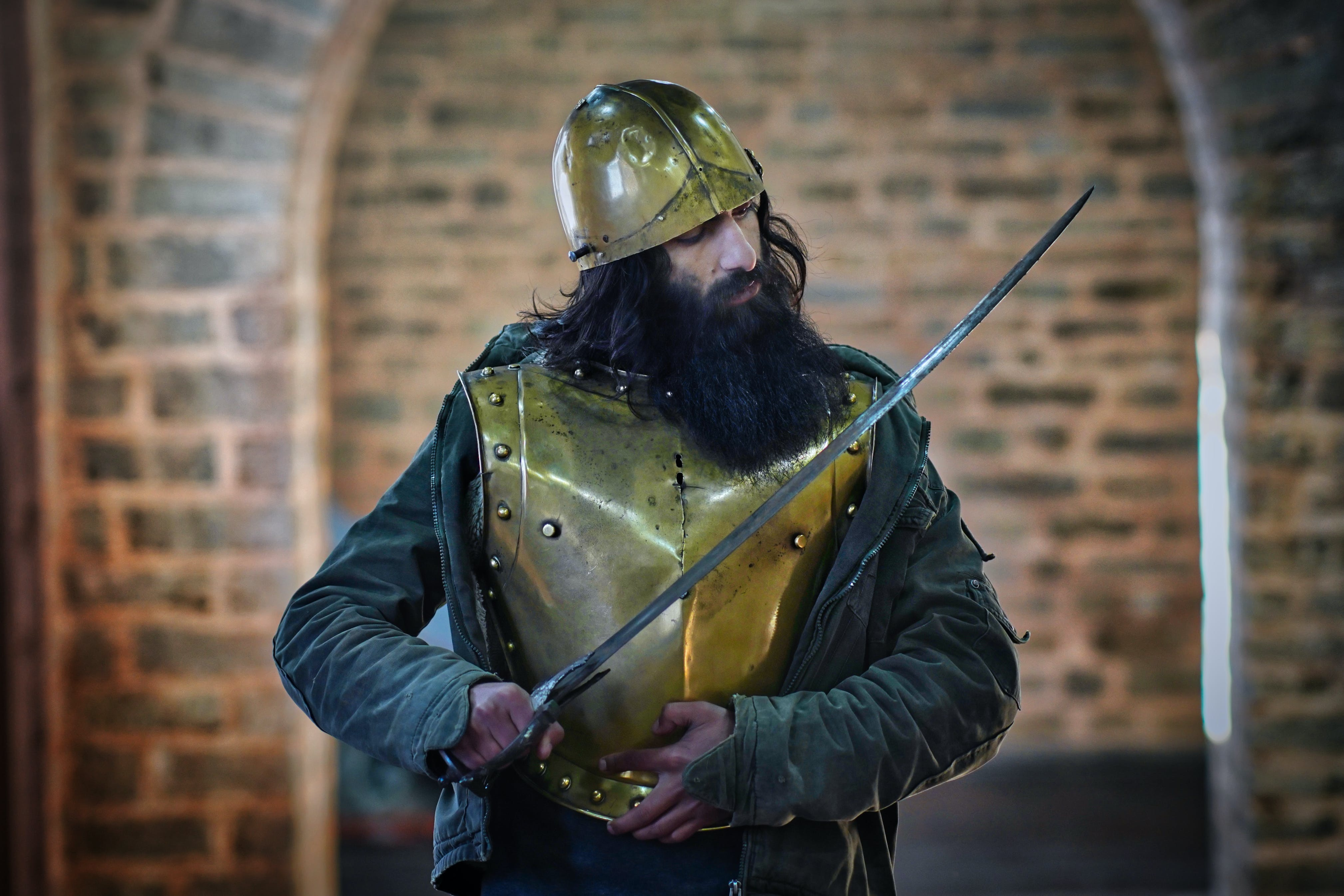 man wearing steel armor, holding a sword